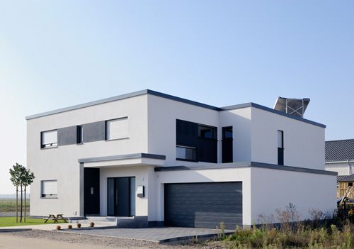 A white house with a low slope roof system.