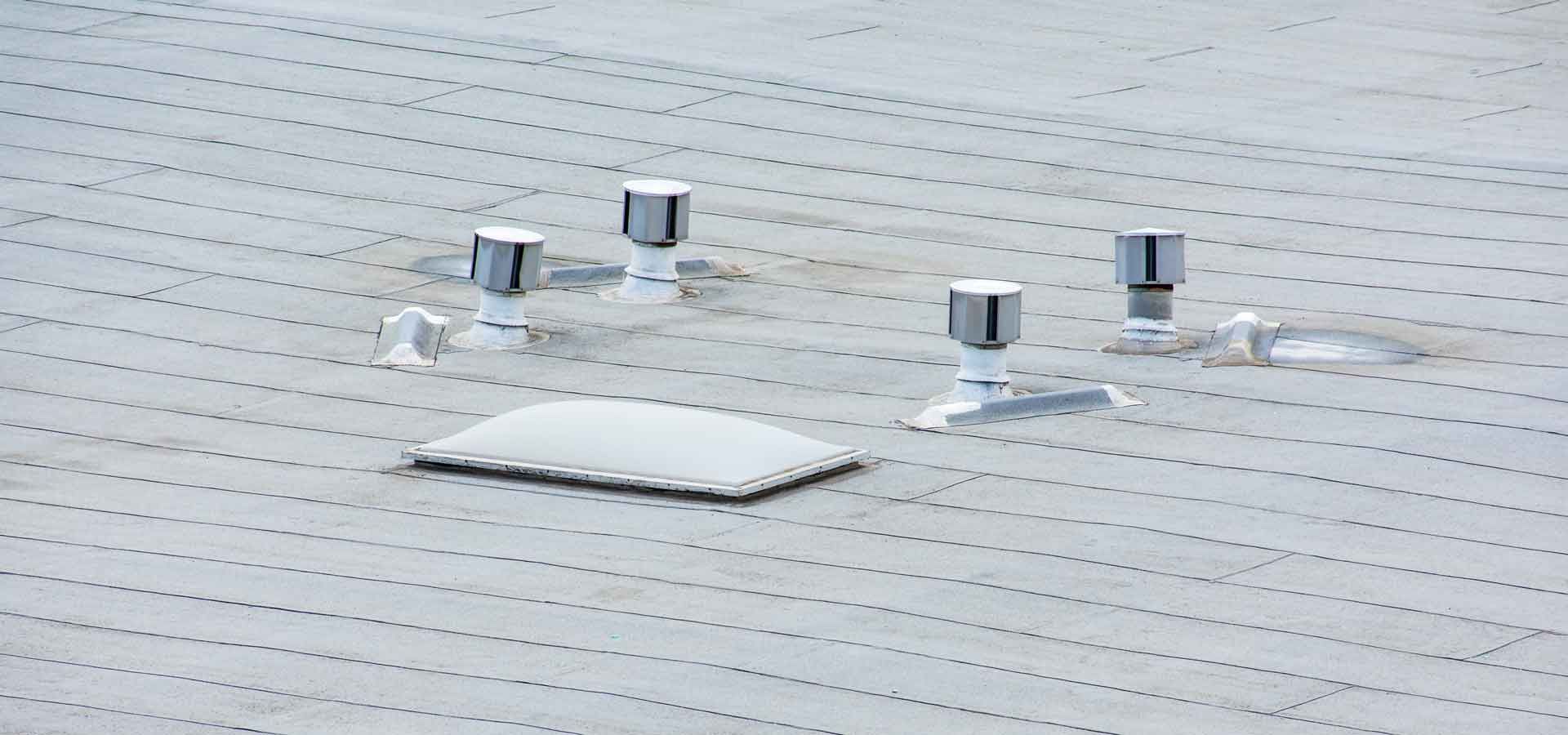 A roof with a lot of vents on it.