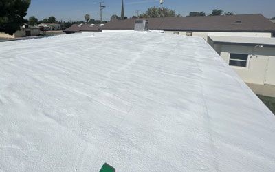 The roof of a building has been sprayed with polyurethane roof coating.