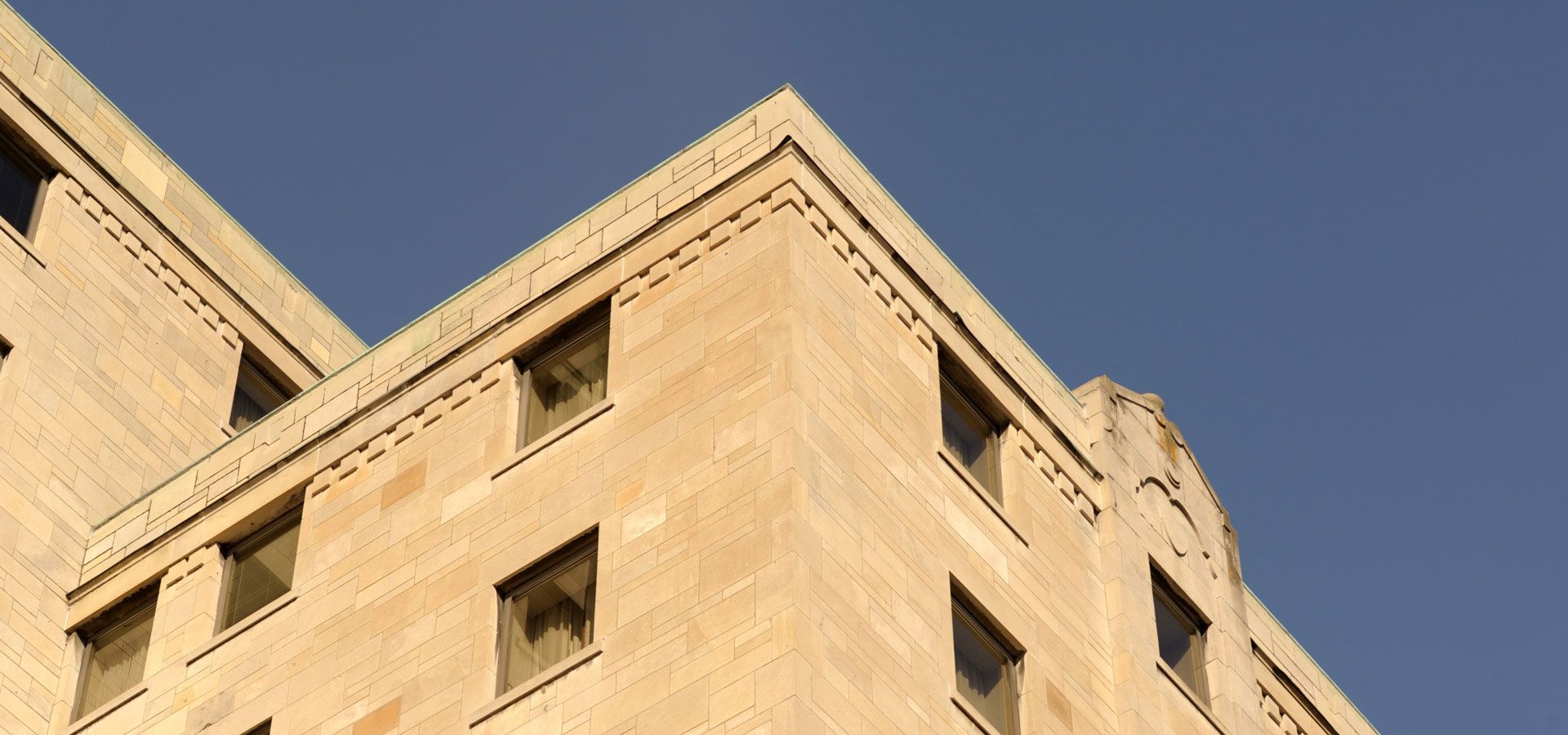 The corner of a building with a blue sky in the background