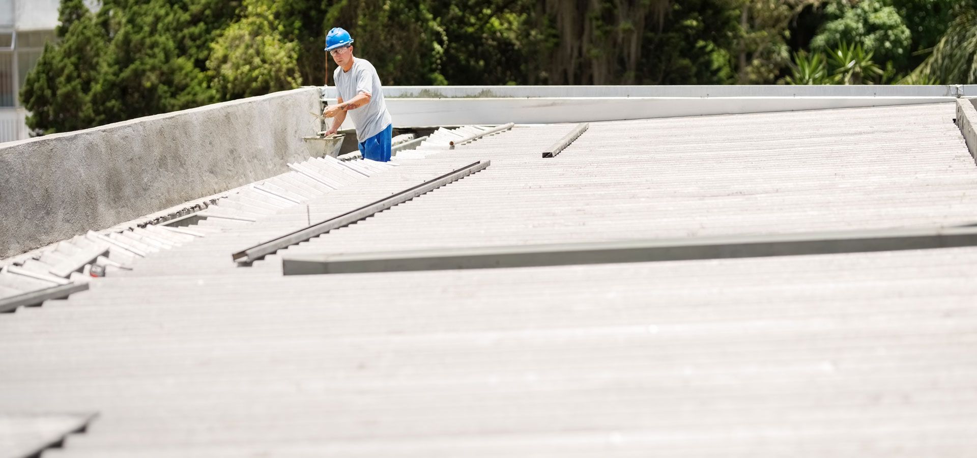 A man is working on the roof of a building.