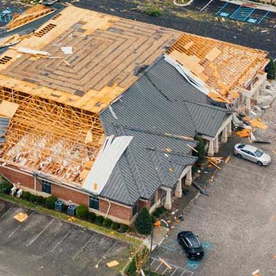 A gutter is leaking water from the roof of a house.