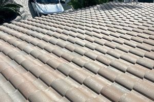 A close-up of a tile roof replacement