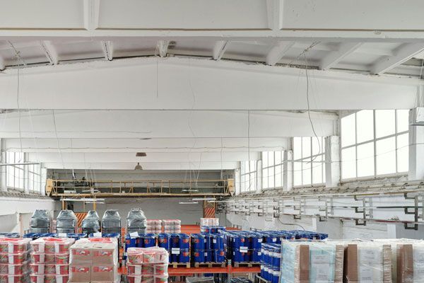 A large warehouse filled with lots of containers and boxes.