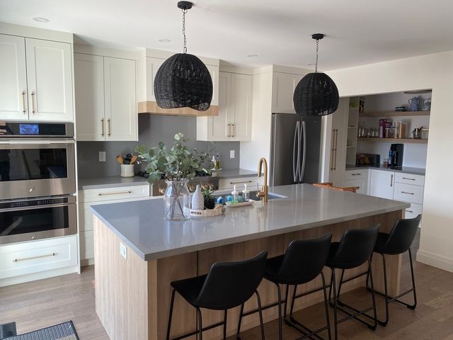 A kitchen with a large island and stools