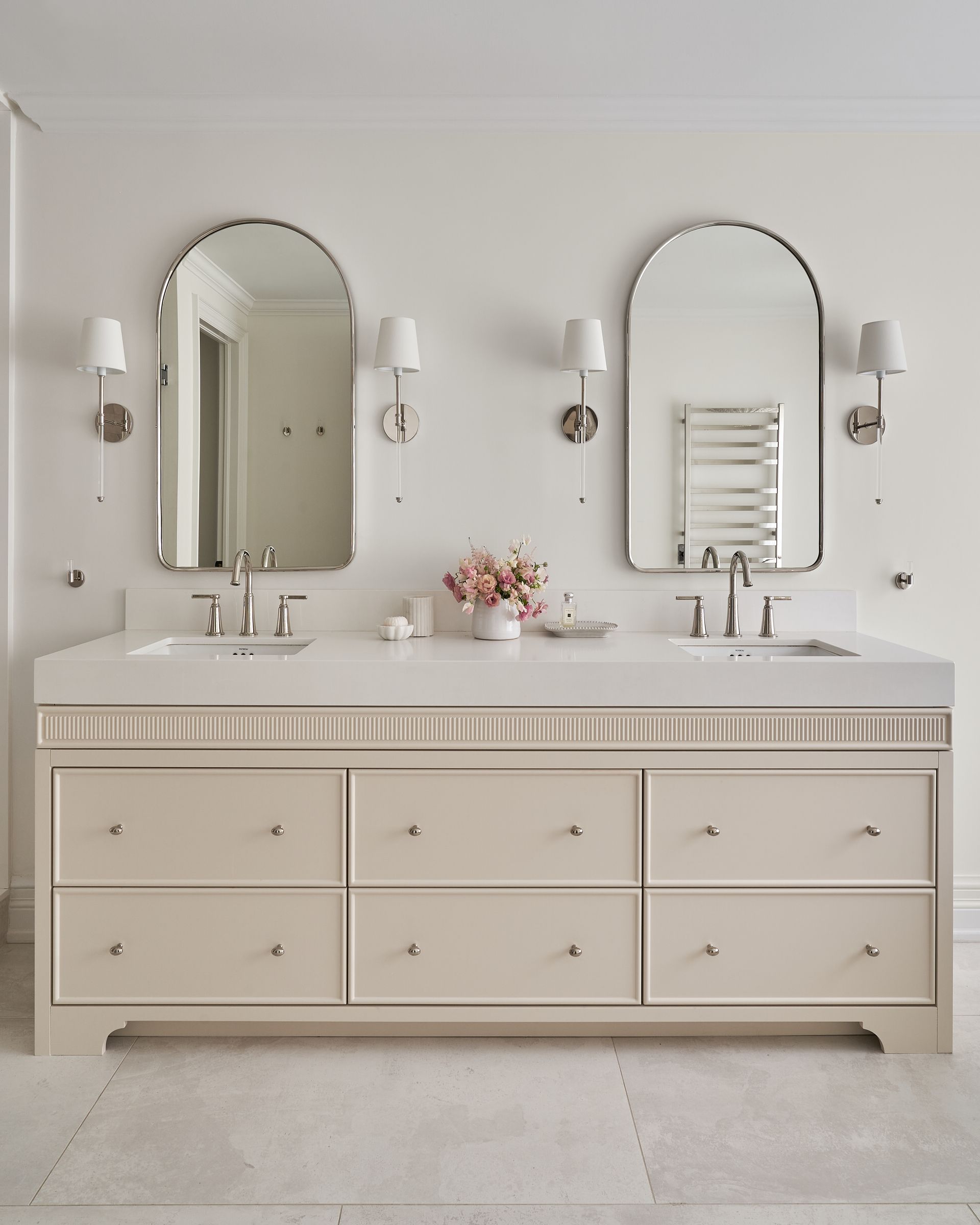 A bathroom with two sinks and two mirrors