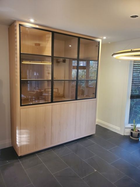 A bathroom cabinet with a mirror and a towel rack