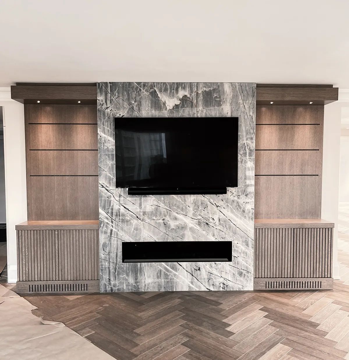 A living room with a marble fireplace and a flat screen tv