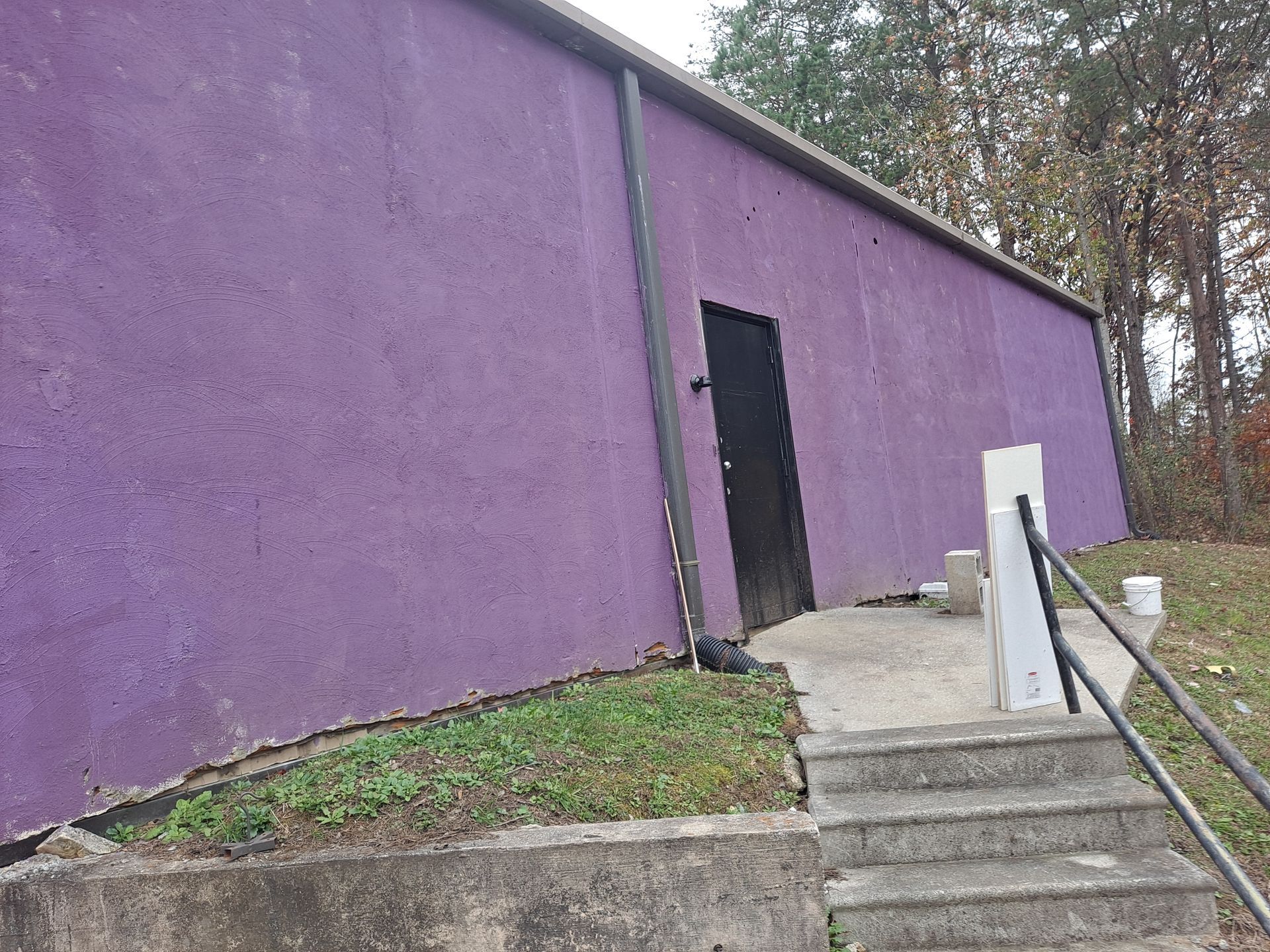 A purple building with stairs leading up to it.