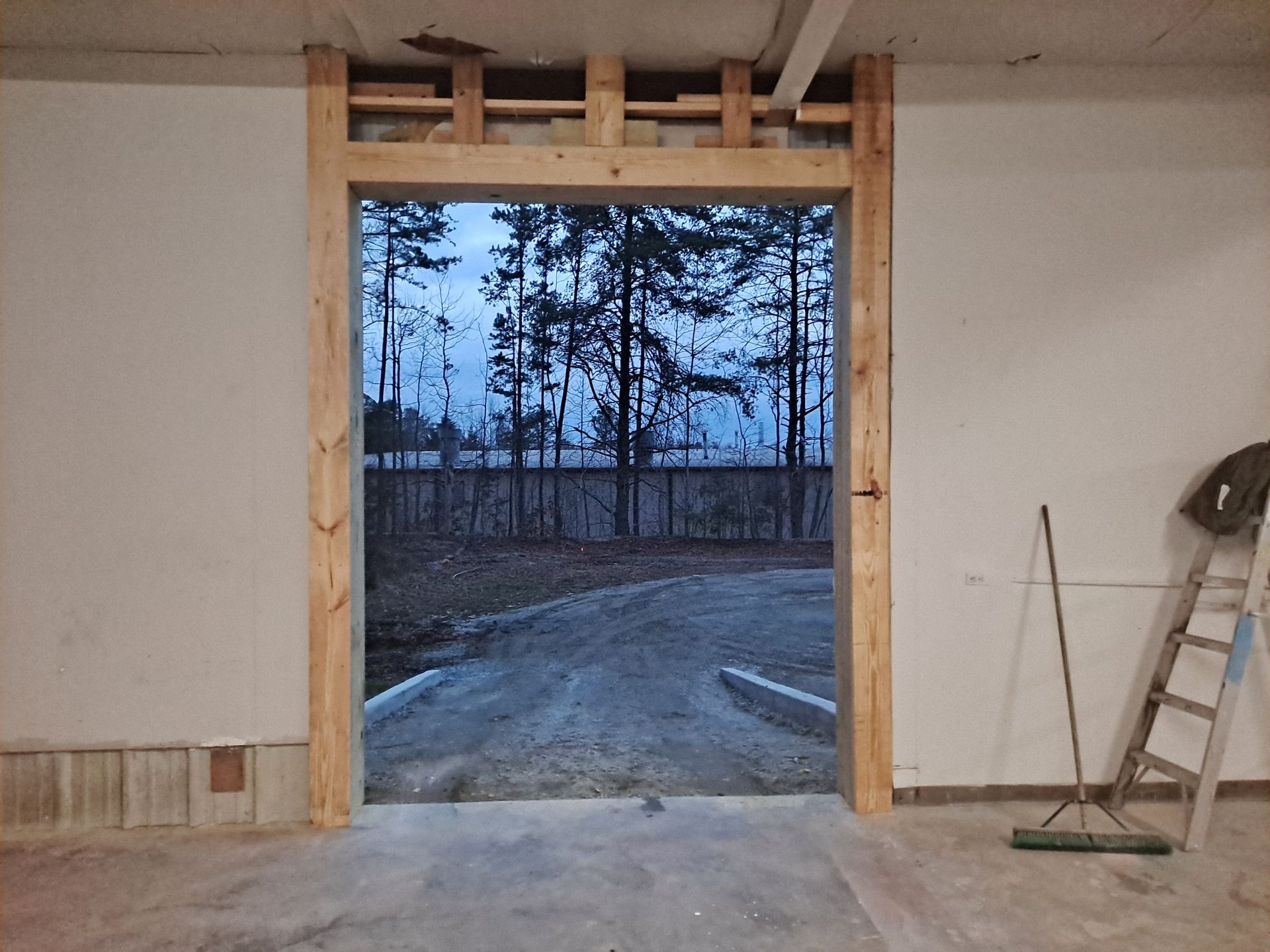 A room with a ladder and a broom in it