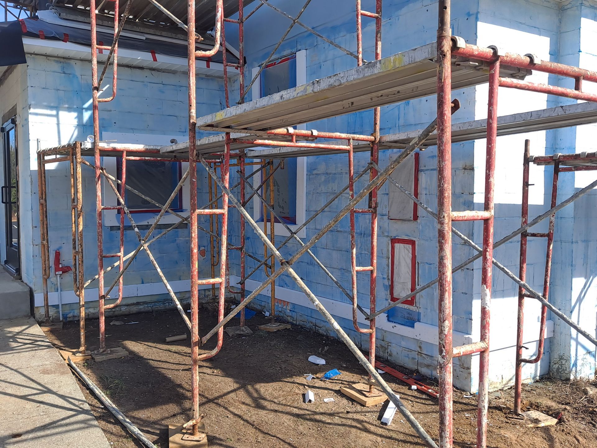 A building under construction with scaffolding in front of it.