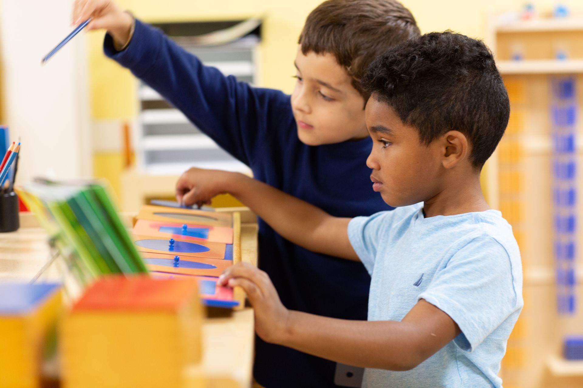Montessori children are playing with a toy that has letters on it