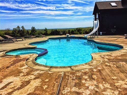 Swimming Pool with a Pool Slide — Pool Maintenance in Simsbury, CT