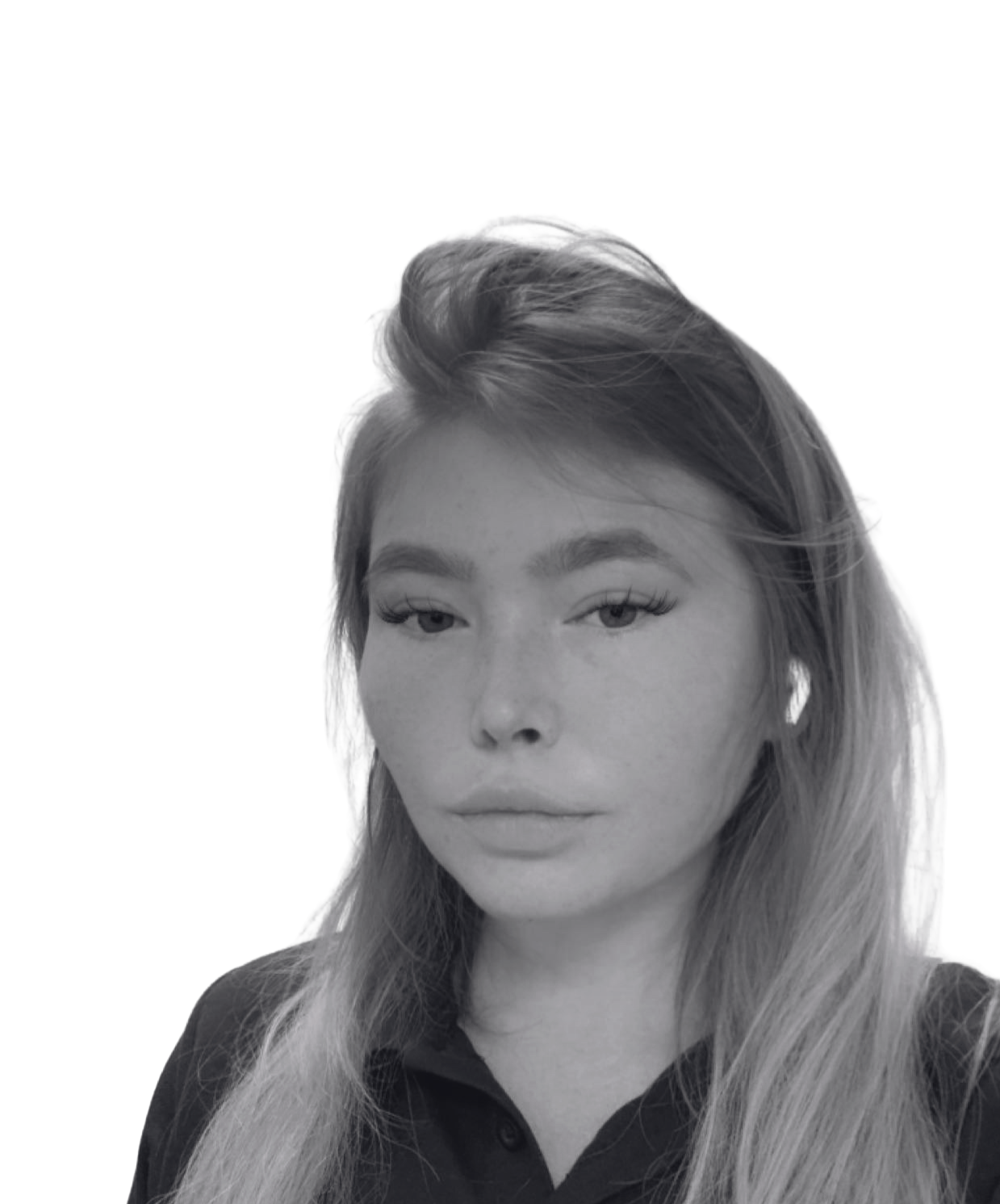 Woman with long hair, wearing an earbud, looking at the camera in black and white.