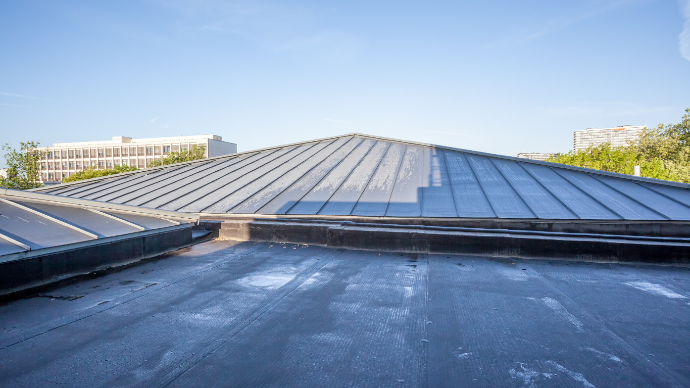 A black roof with a blue sky in the background.