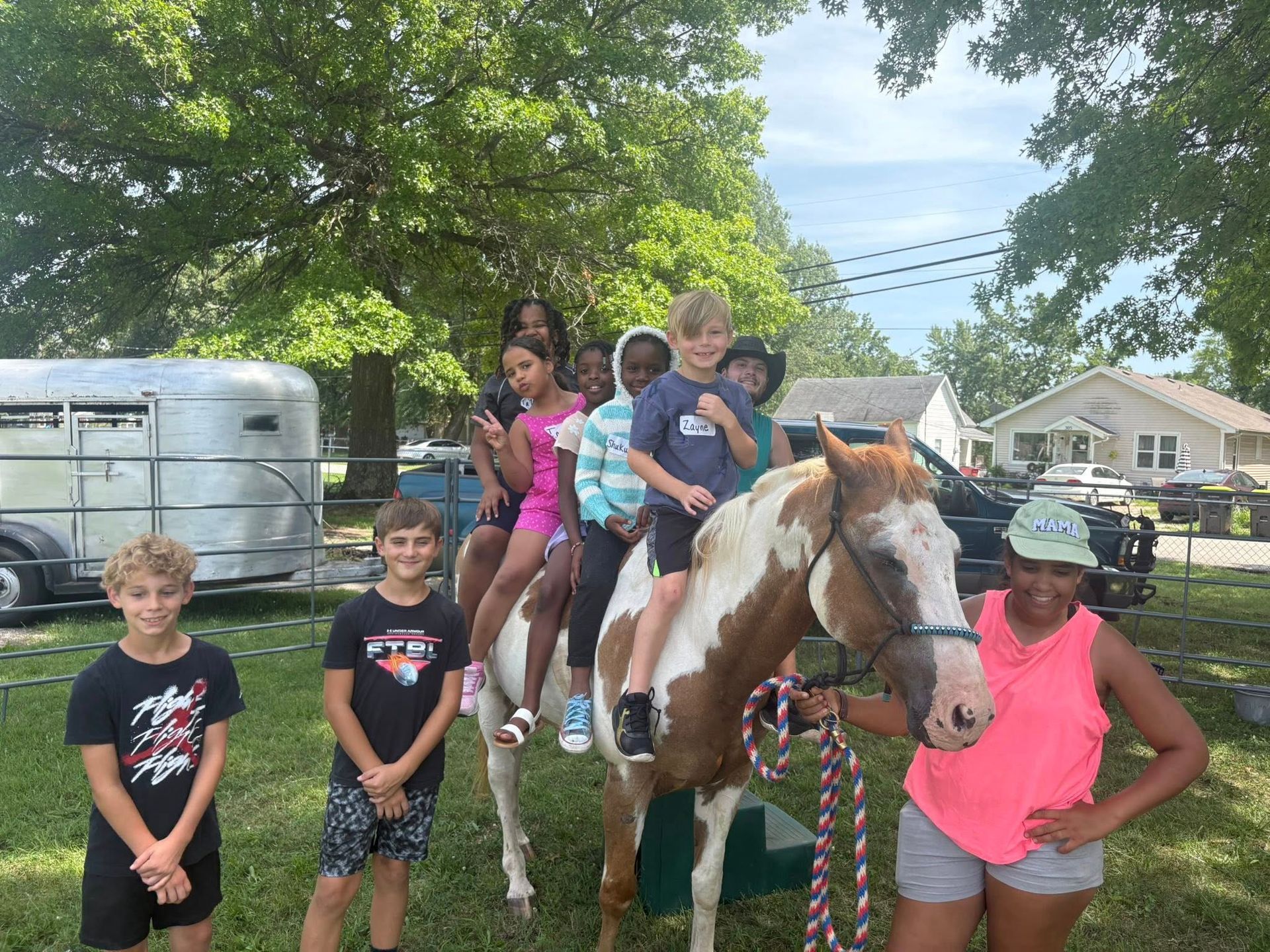 A group of children are riding on the back of a horse.