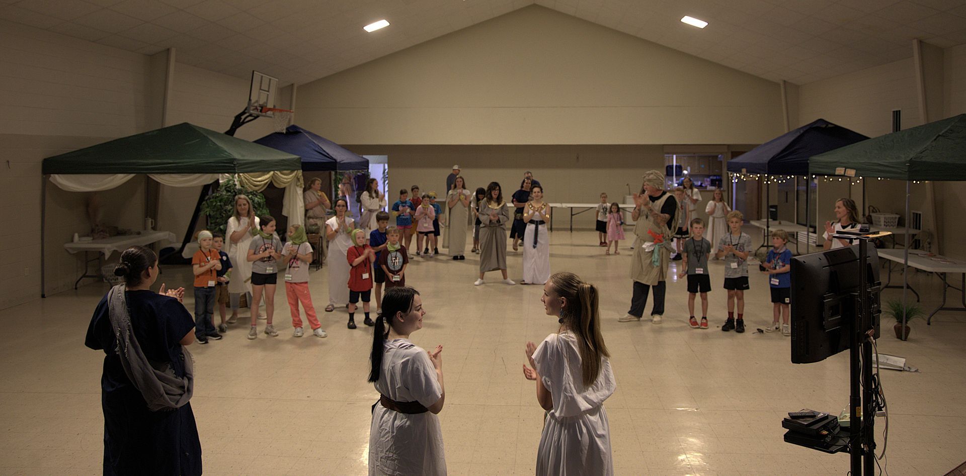 A group of people are standing in a large room.