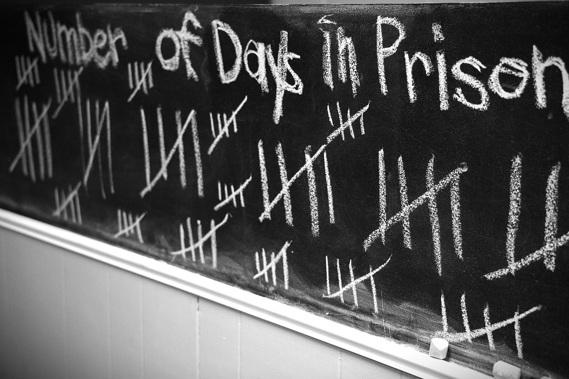 A blackboard with the number of days in prison written on it