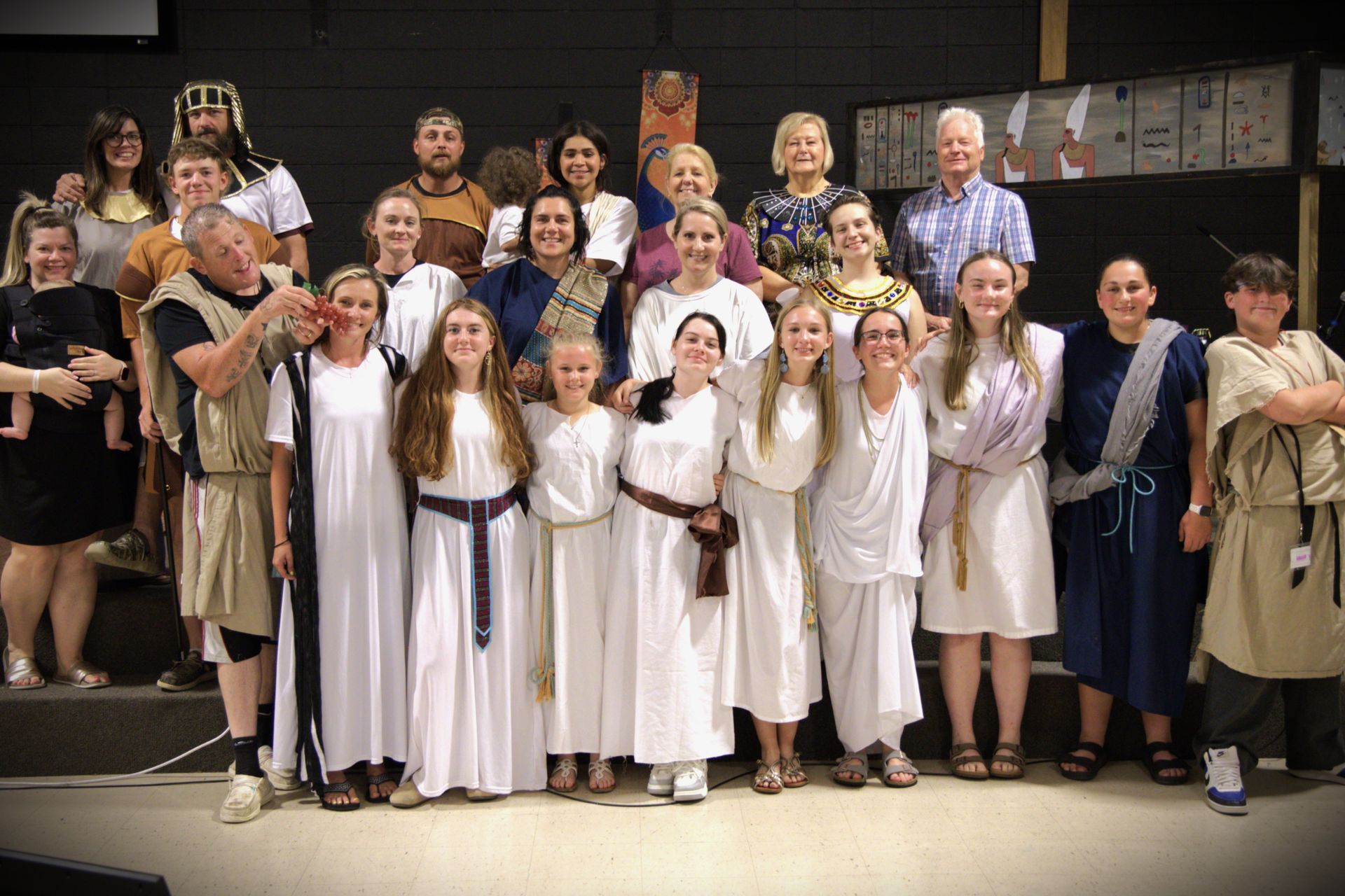A group of people dressed in ancient greek costumes are posing for a picture.