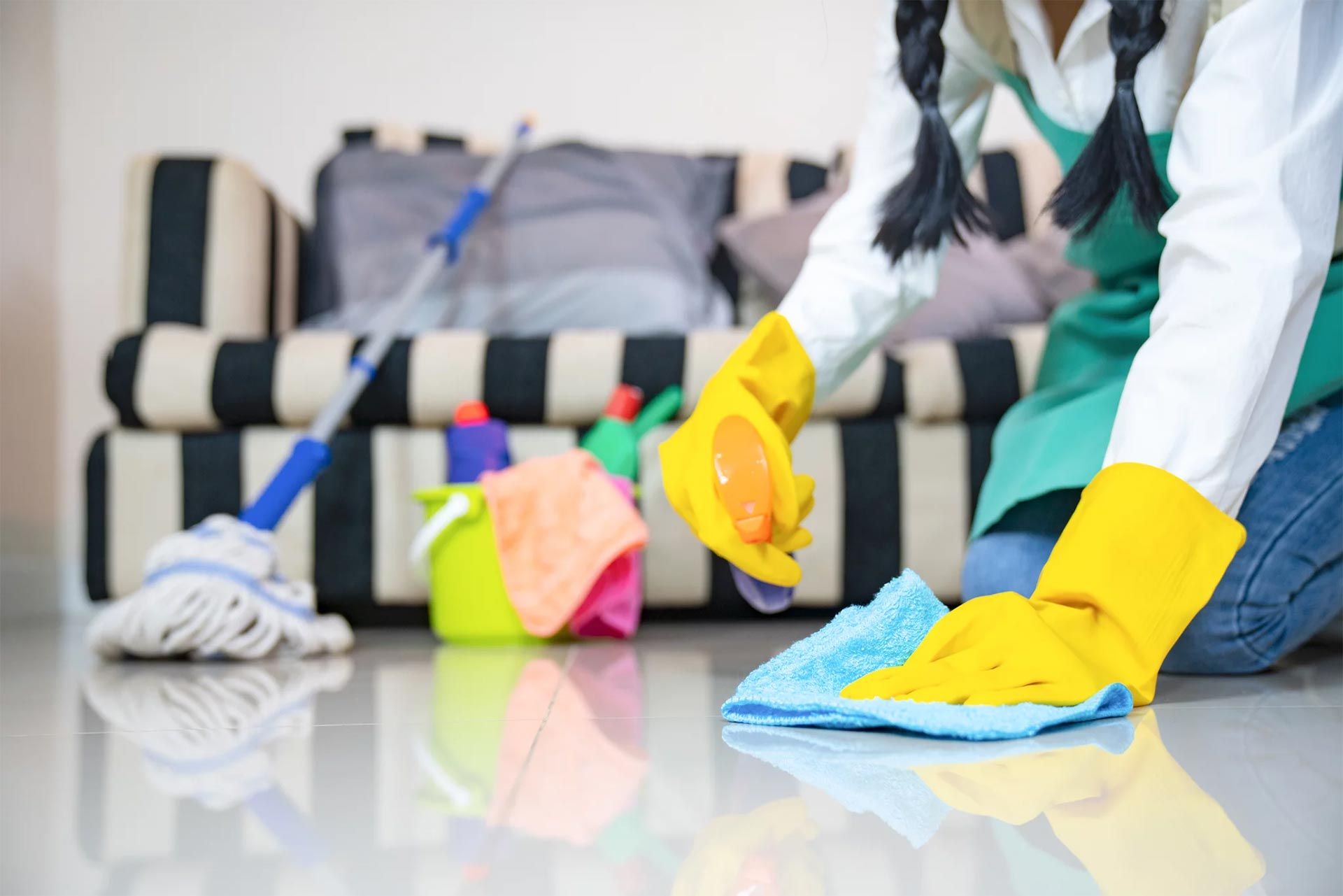 Experienced cleaning professionals refreshing a stylish apartment and living room, mopping hardwood floors, disinfecting high-touch surfaces, cleaning windows, and organizing the space for a spotless finish. The image highlights trusted maid service, apartment cleaning services, professional cleaning services, and Naperville house cleaning services, creating a clean, healthy, and welcoming home.