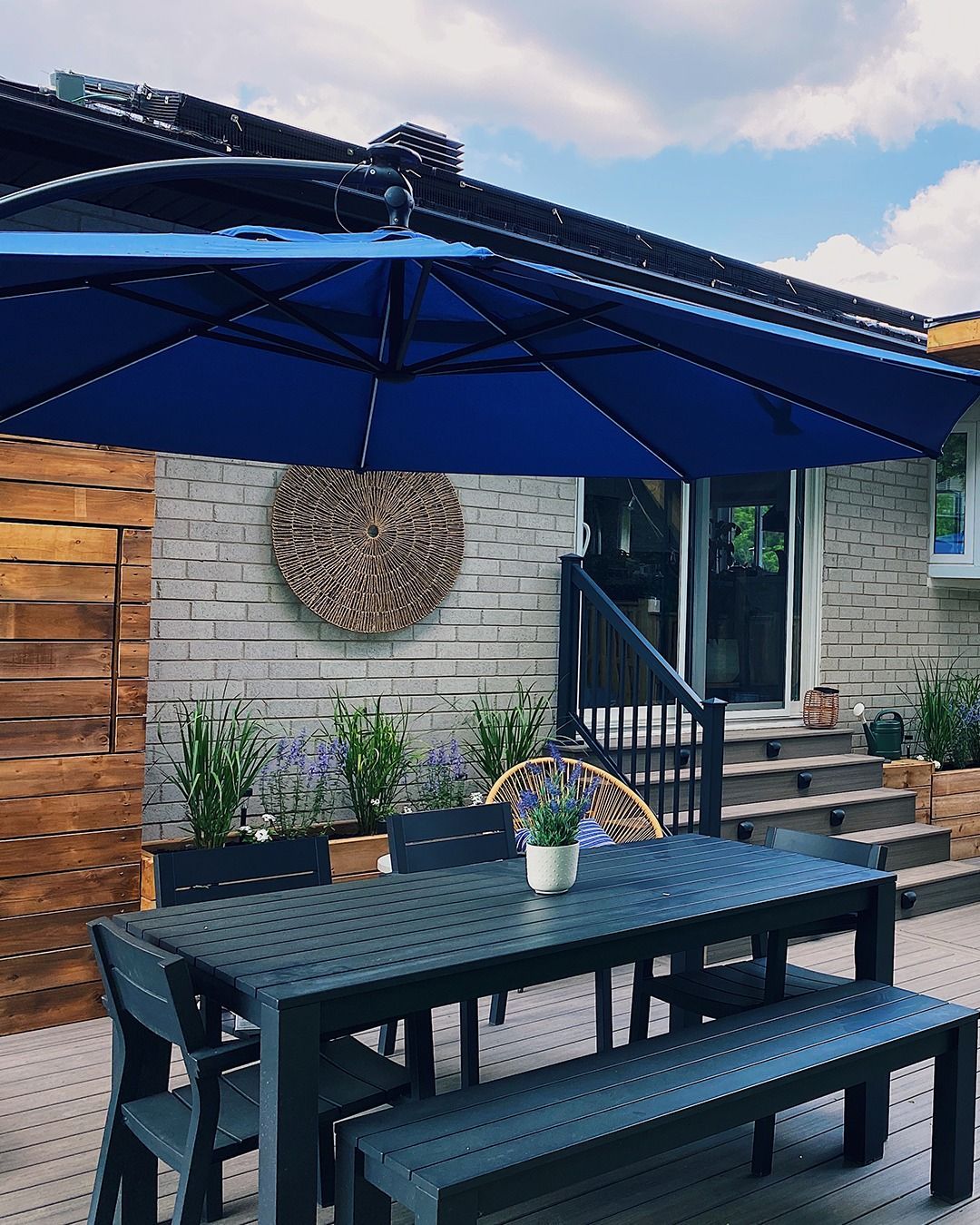 A patio with a table and chairs under an umbrella.