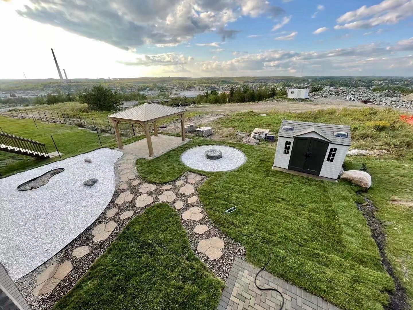 An aerial view of a backyard with a dog house and a gazebo.