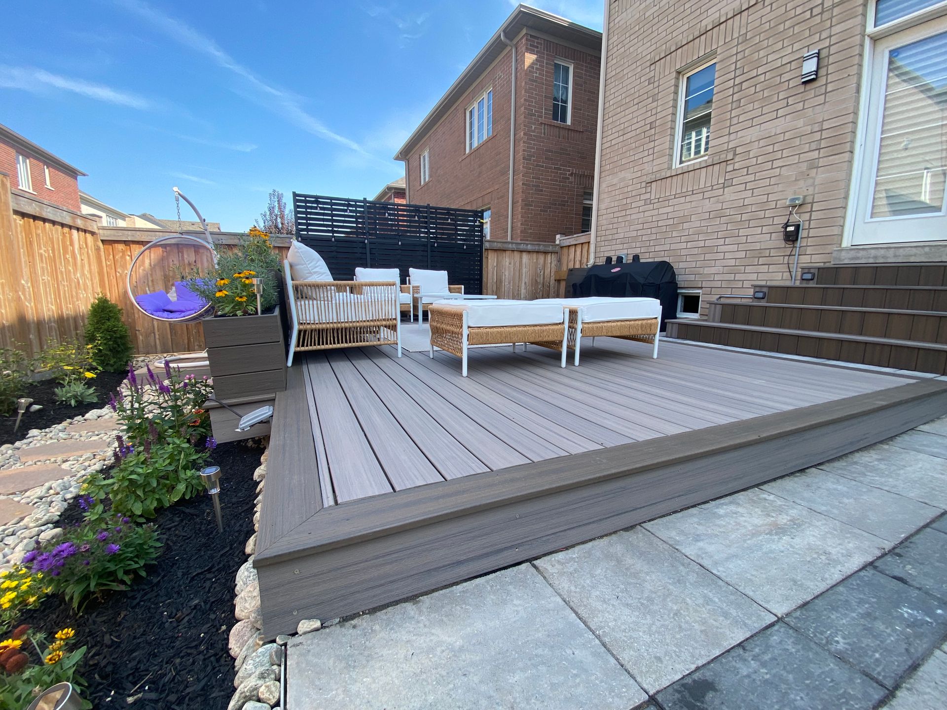 There is a deck with a lot of furniture on it.