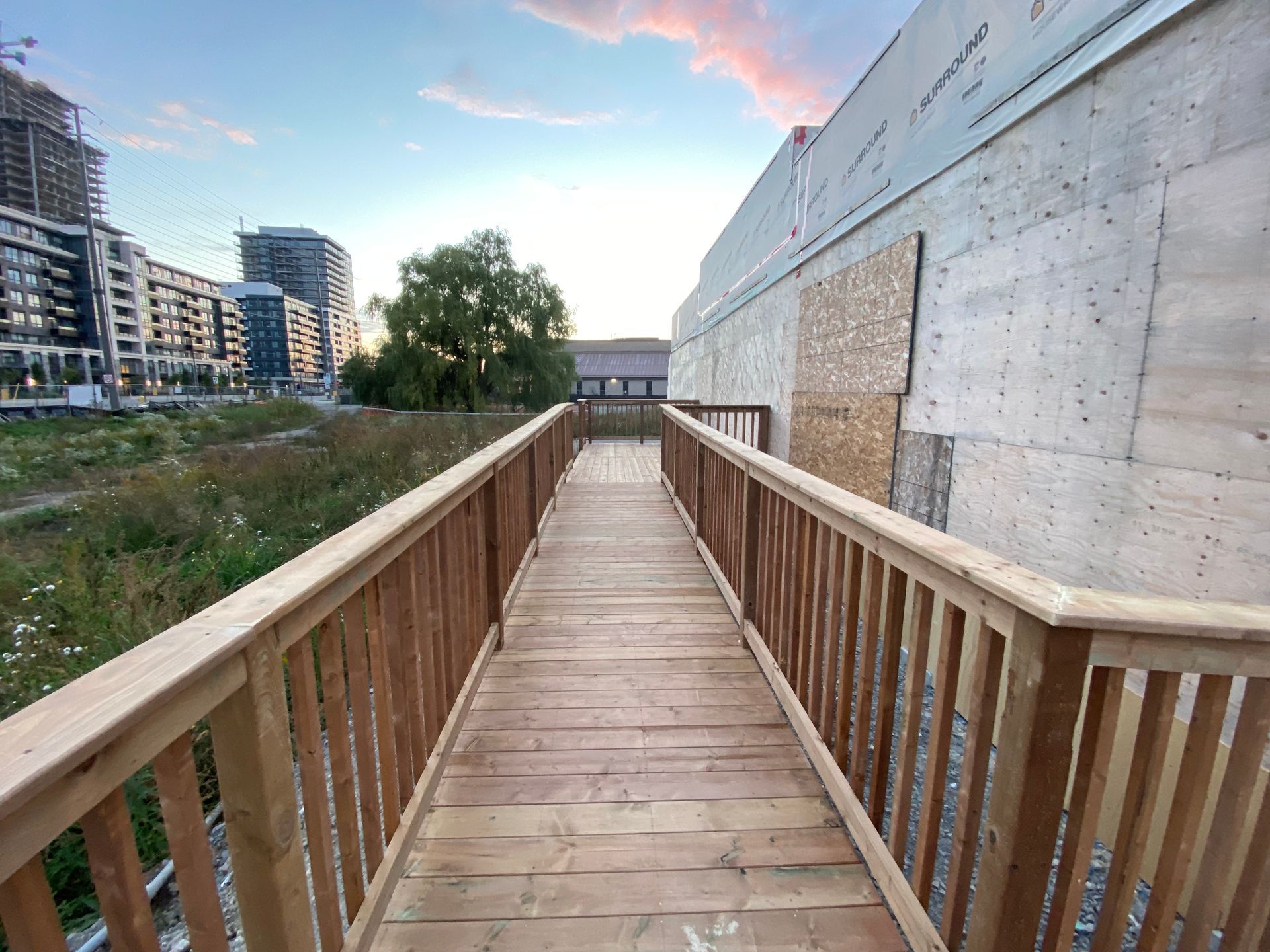A wooden bridge over a body of water in a city