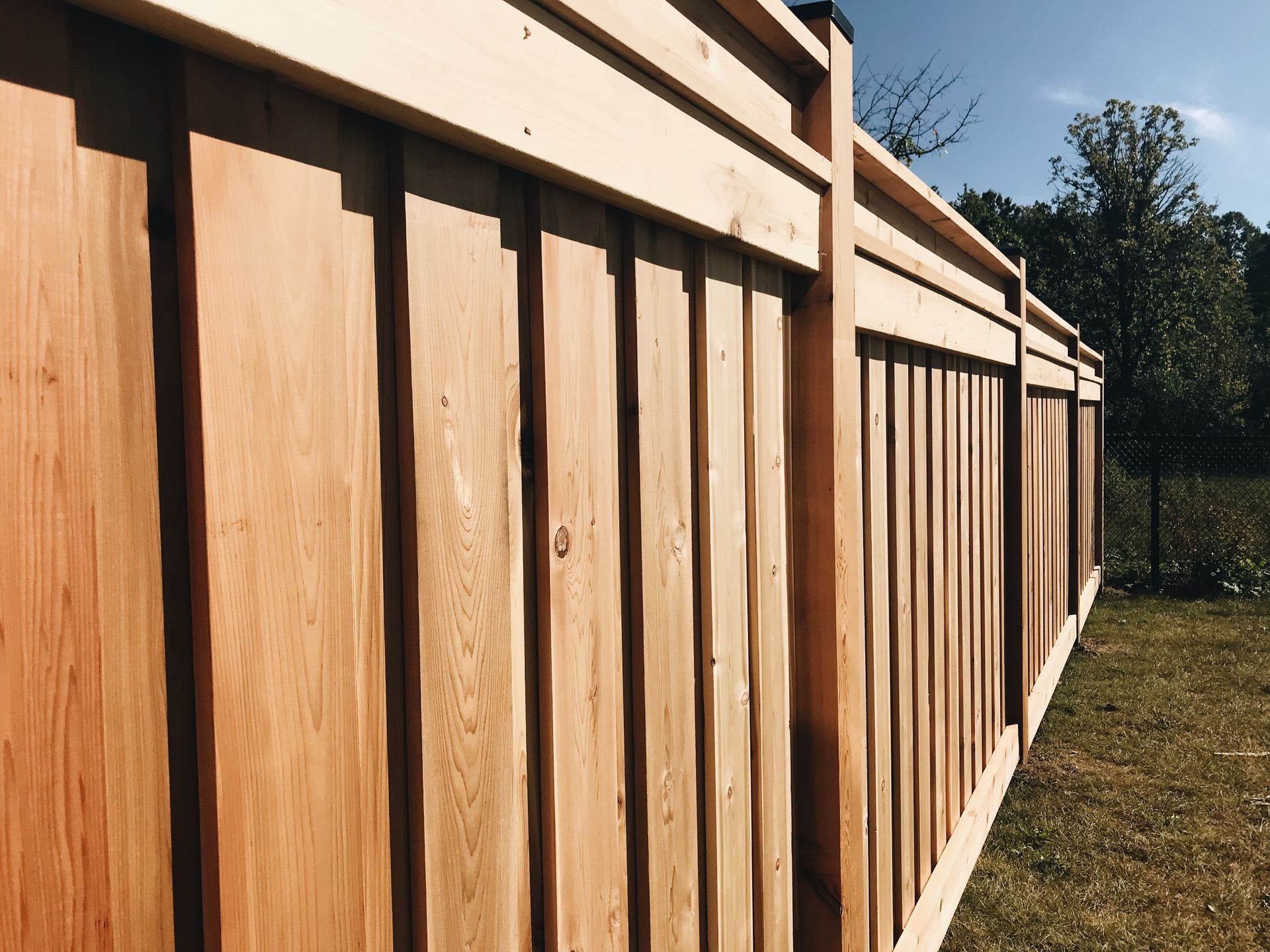 A close up of a wooden fence in a backyard