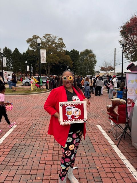 A man in a yellow shirt and a woman in a red hat are posing for a picture.