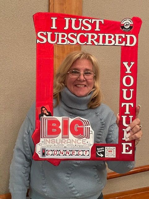 A woman is holding a sign that says i just subscribed youtube