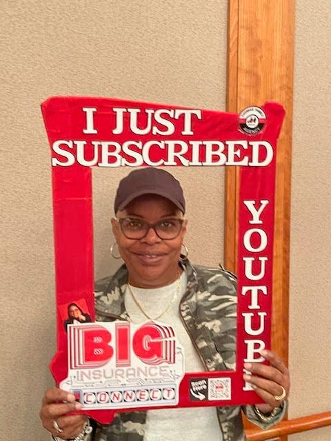 A woman is holding a sign that says i just subscribed youtube