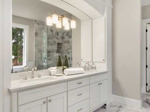 Large Mirror and Stylish Lighting Fixtures in Modern Bathroom