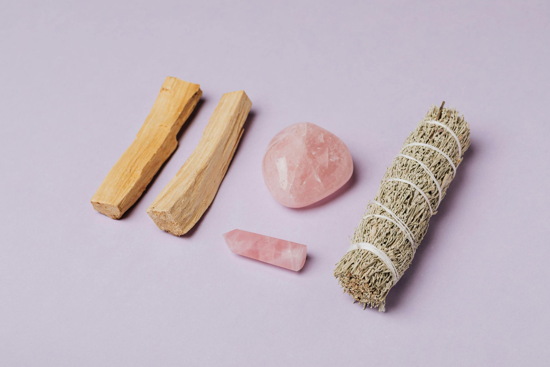 There are many different types of sticks and crystals on the table.