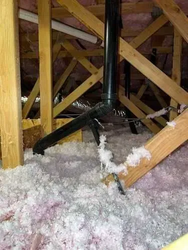 There is a pipe in the attic filled with insulation.