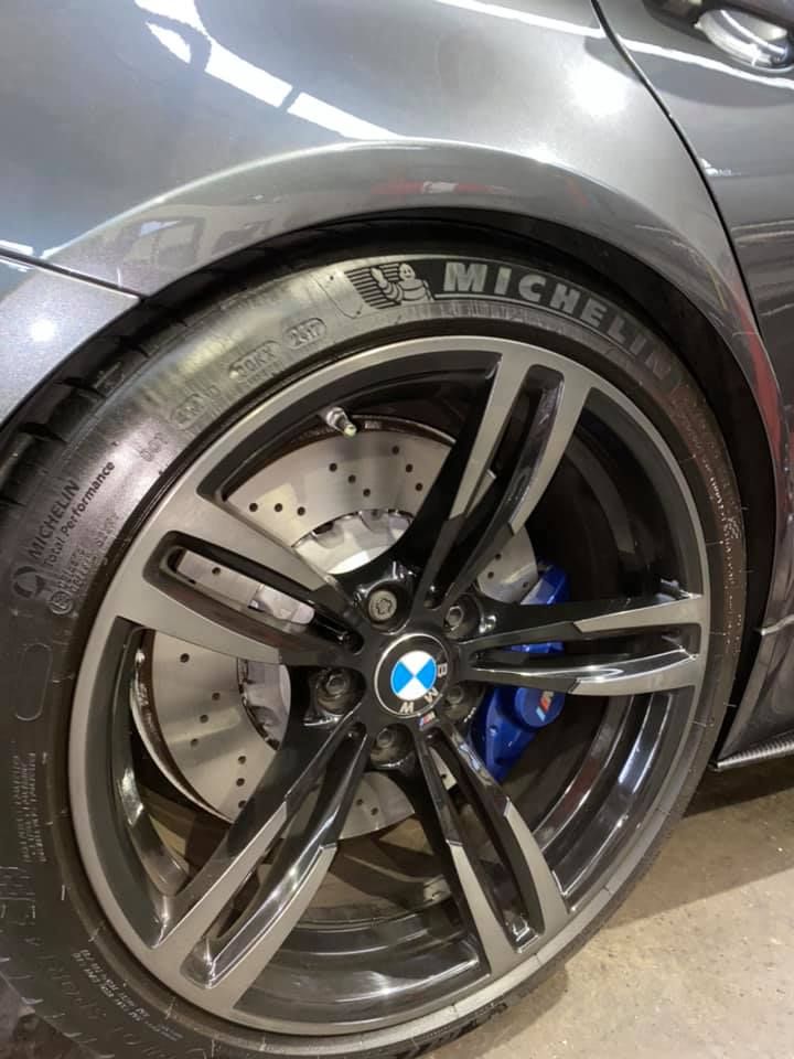 A close up of a car wheel with a michelin tire on it.