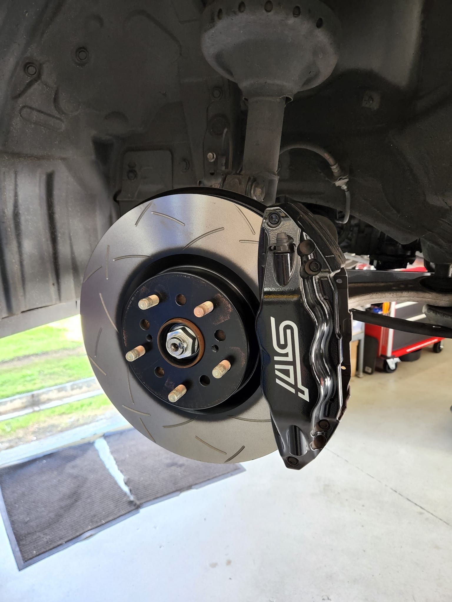 A close up of a brake disc on a car.