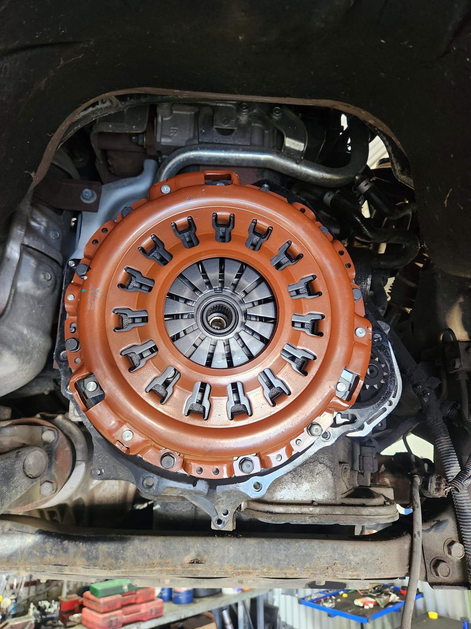 A close up of a clutch cover on a car engine.