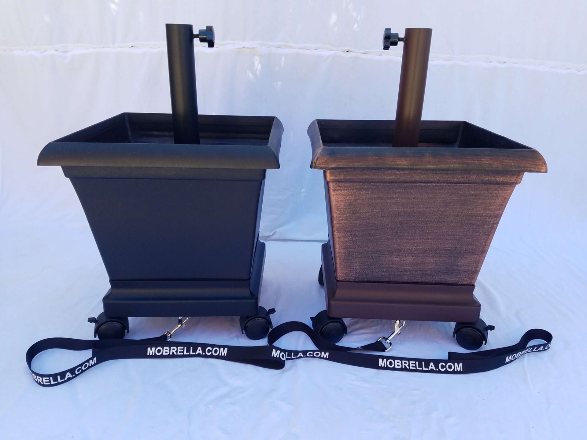 Two planters with umbrellas attached to them and a lanyard that says umbrella.com