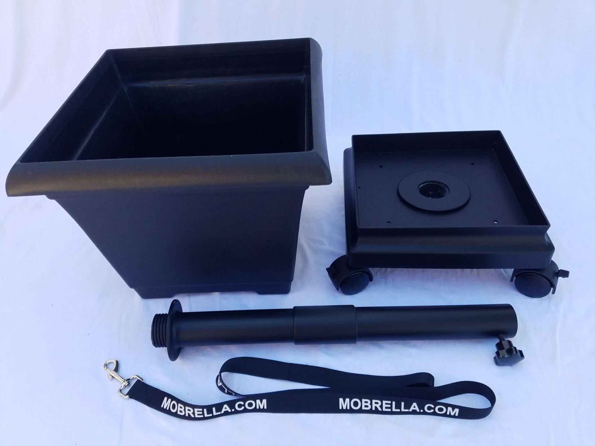 A black container with a lanyard that says norella.com