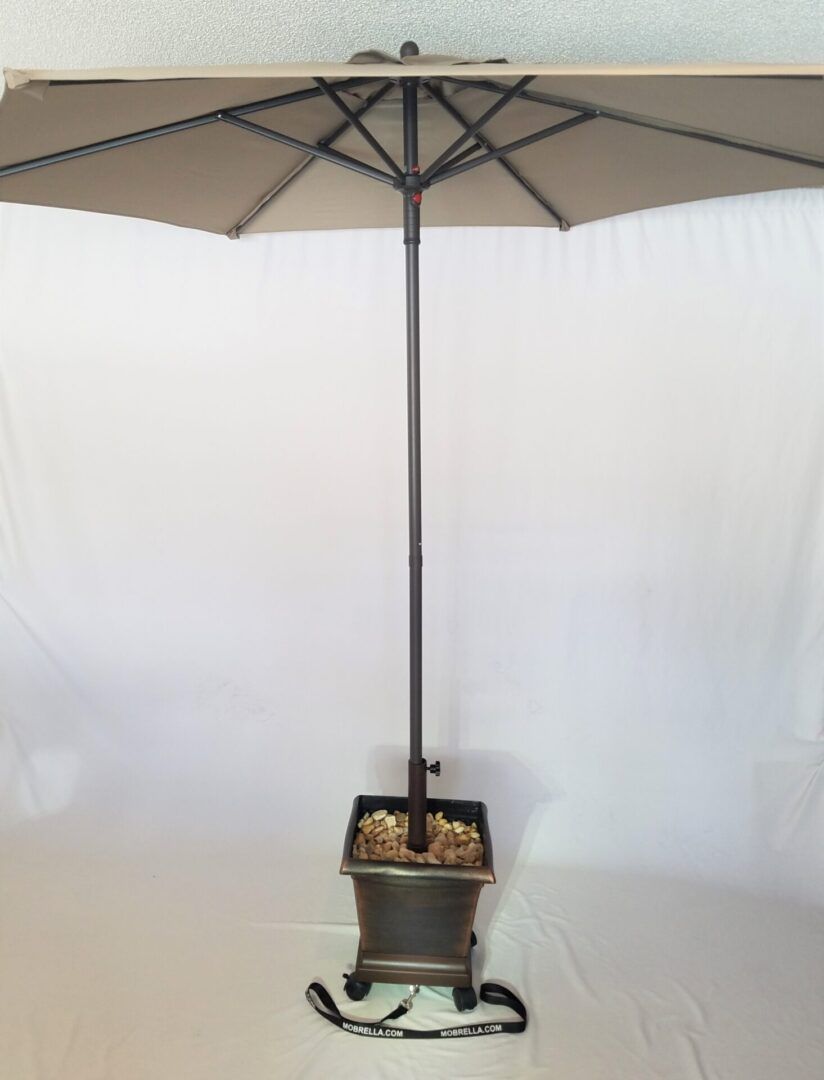 A large umbrella with a planter attached to it