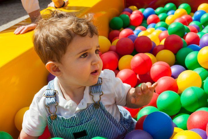 Boy playing in a plastic ball pool