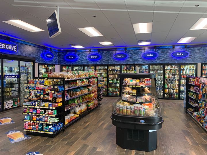 The inside of a J&T Investments Inc. managed convenience store that is filled with lots of food and drinks.