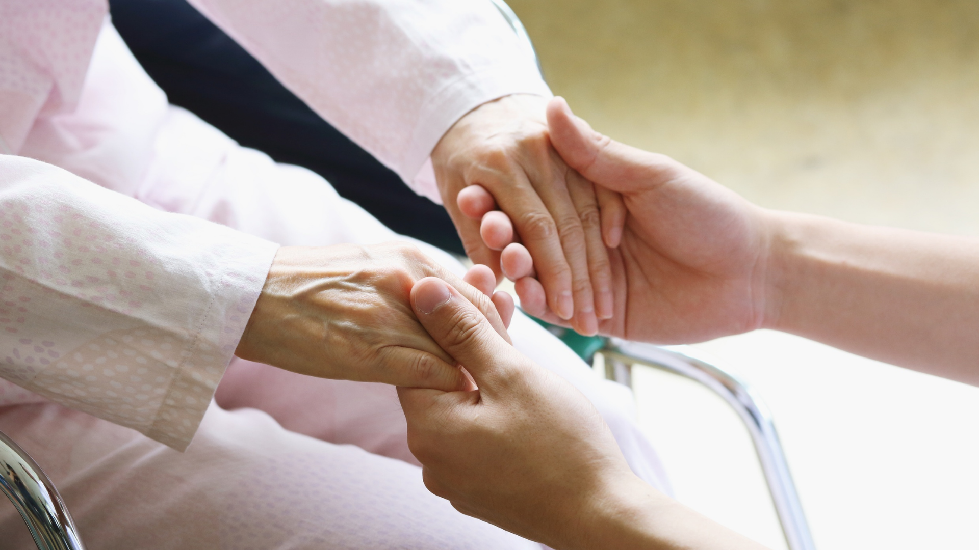 Nurse taking a patient's blood pressure with a stethoscope in a medical setting.