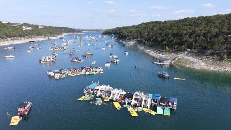 aerial view of lake travis party boats via a drone