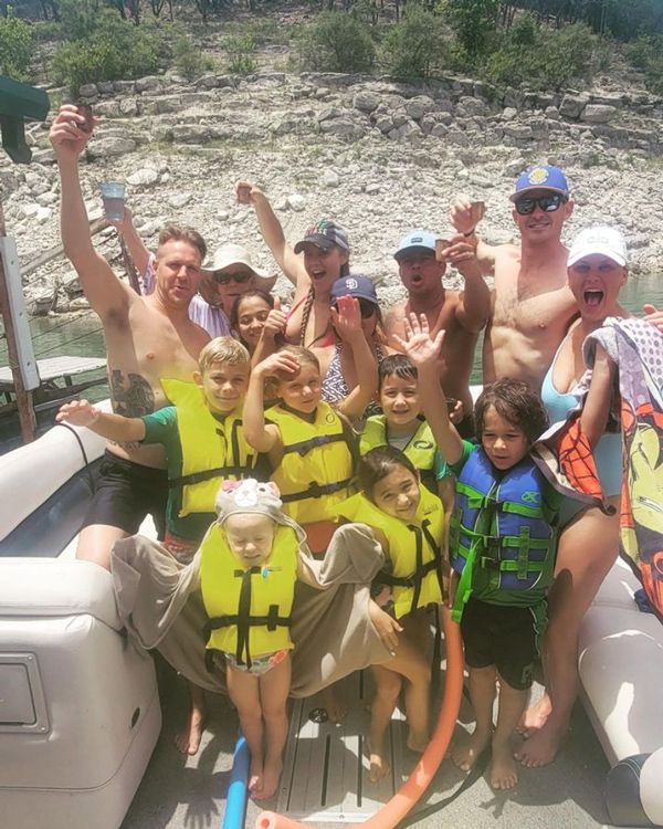 family posing together on a Lake Travis boat rental from Lone Star Party Boats Lake Travis