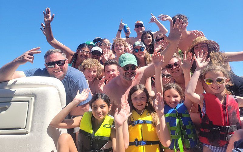 Family posing together on a family-friendly party boat in Lake Travis, Texas
