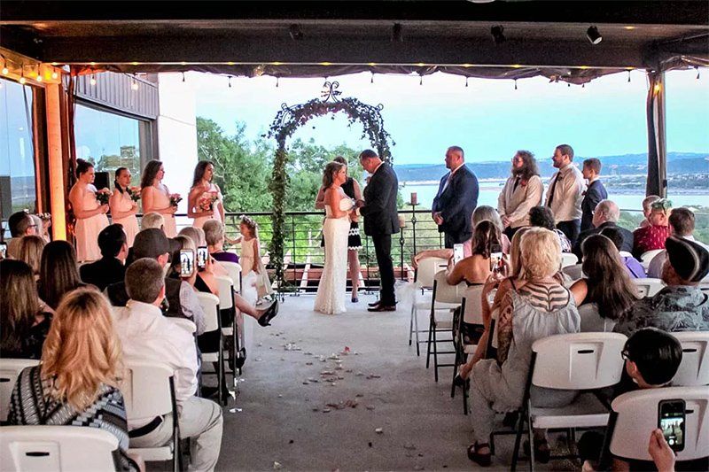 wedding being performed at Terrace at Highland Lakes with a view of Lake Travis in the background