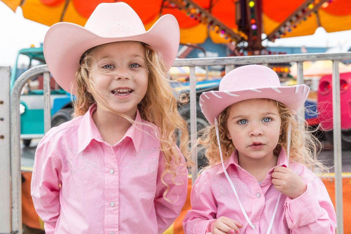 two girls in pink cowgirl outfits having fun in Austin, Texas