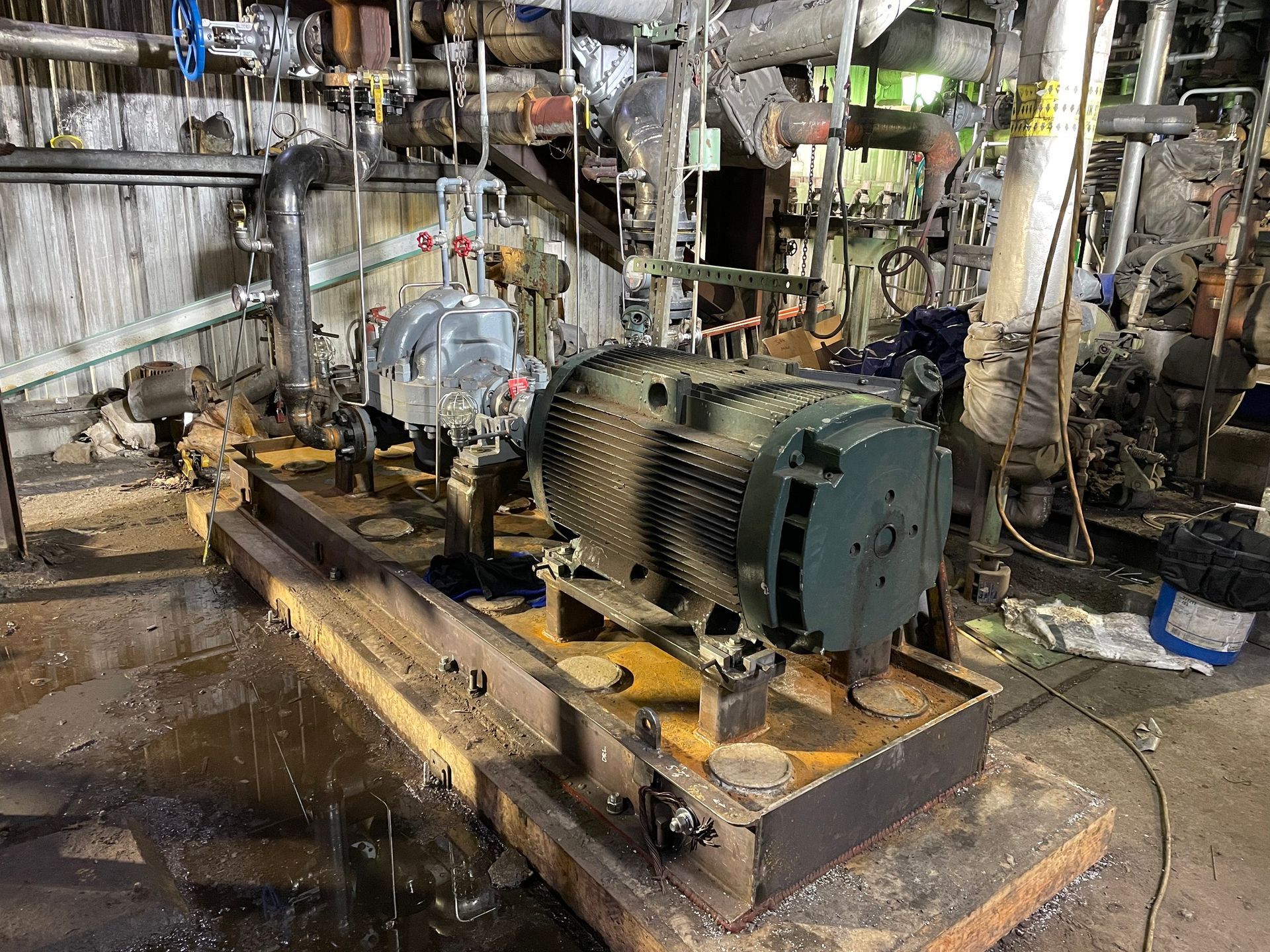 A large machine is sitting on top of a wooden platform in a factory.